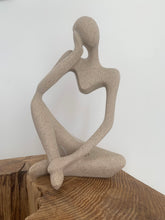 Load image into Gallery viewer, stone effect thinking figure, styled on top of a wooden block
