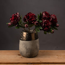 Load image into Gallery viewer, A stunning burgundy peony rose stem, chosen for its realism.   This wild summer faux flower looks beautiful in a single stem vase or just pop a few of them together in a large vase for a stunning classic look for Spring and Summer. Styled here is this photo are 3 peony stems in a vase, a bronze textured vase, a bronze coloured band around the top of the vase and the lower half is a textured look in a cream colour. A real statement vase 
