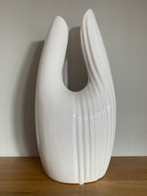 Load image into Gallery viewer, A gloss white contemporary case with a curved opening at the front and ribbed detailing half way around the vase and the other half smooth gloss
